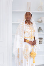 Load image into Gallery viewer, Woman wearing white Somali bridal/wedding dirac.

