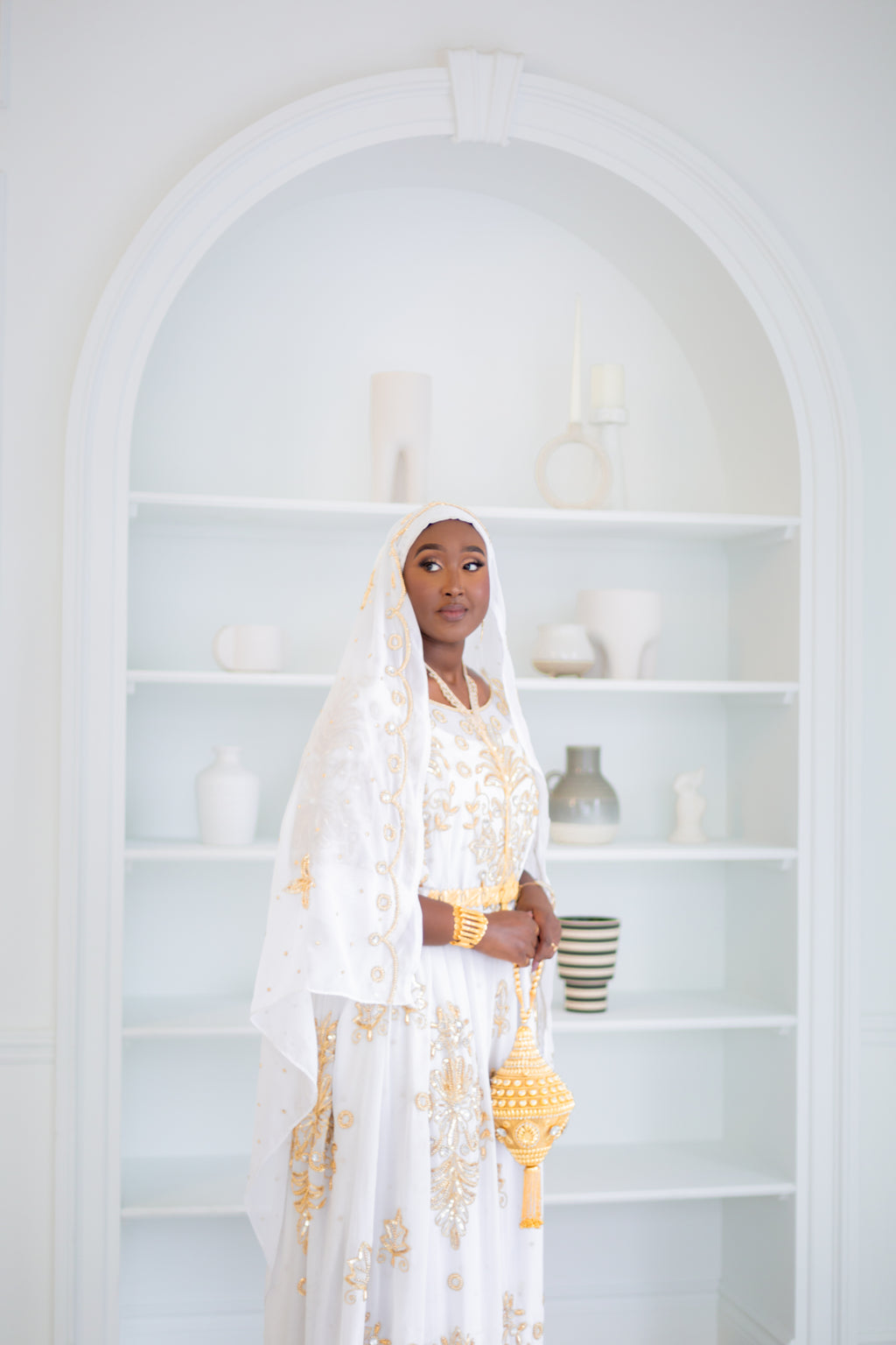 Woman wearing white Somali bridal/wedding dirac.