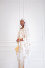 Load image into Gallery viewer, Woman wearing white Somali bridal/wedding dirac.
