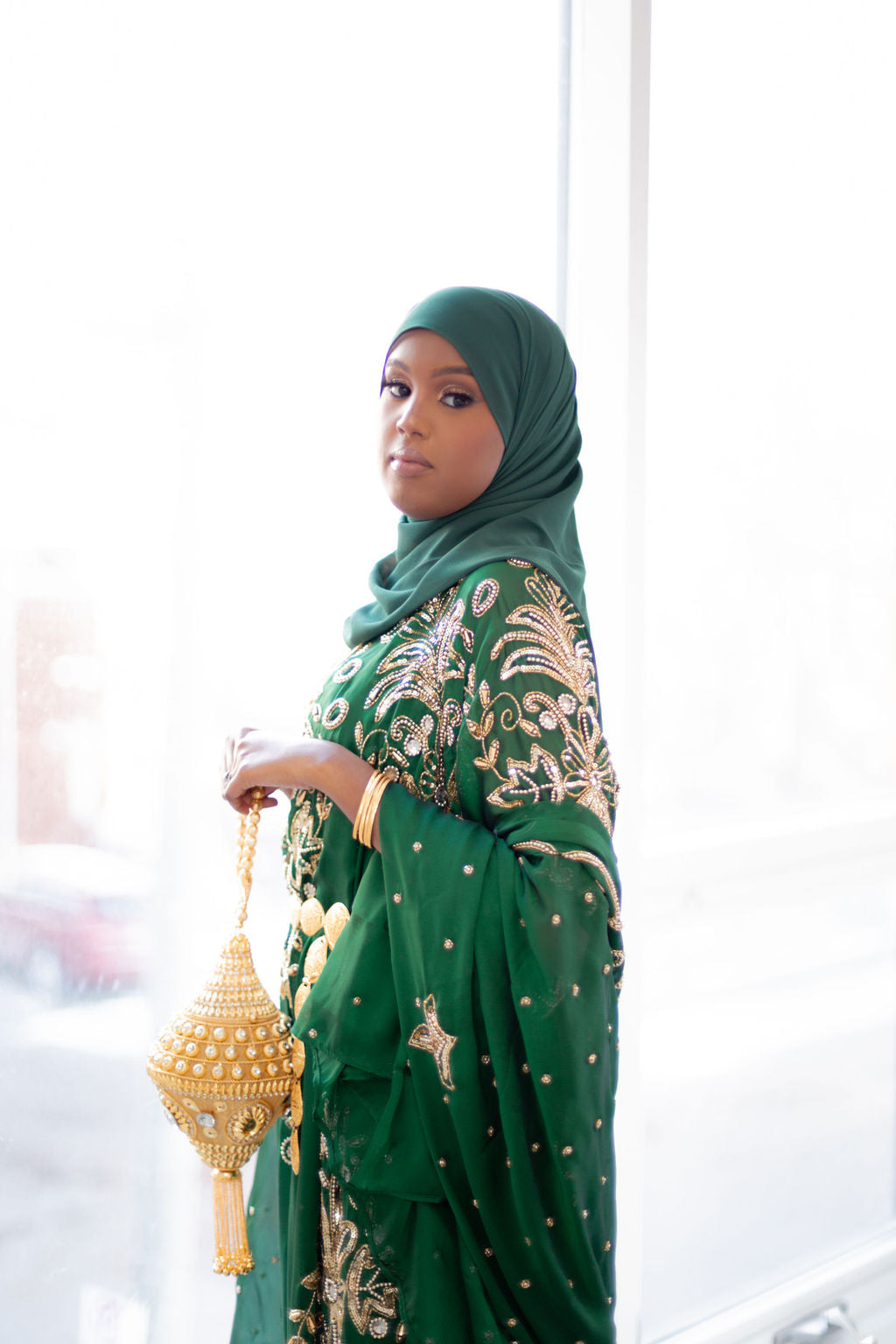 Woman wearing green Somali bridal/wedding dirac.