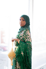 Load image into Gallery viewer, Woman wearing green Somali bridal/wedding dirac.
