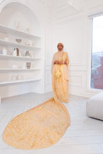 Load image into Gallery viewer, Woman wearing champagne gold Somali bridal/wedding dirac.
