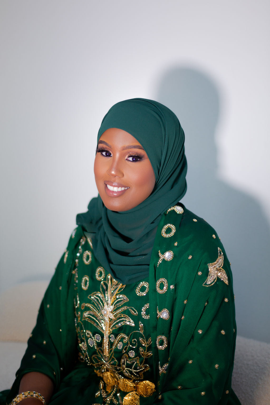 Woman wearing green Somali bridal/wedding dirac.