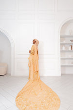 Load image into Gallery viewer, Woman wearing champagne gold Somali bridal/wedding dirac facing away.
